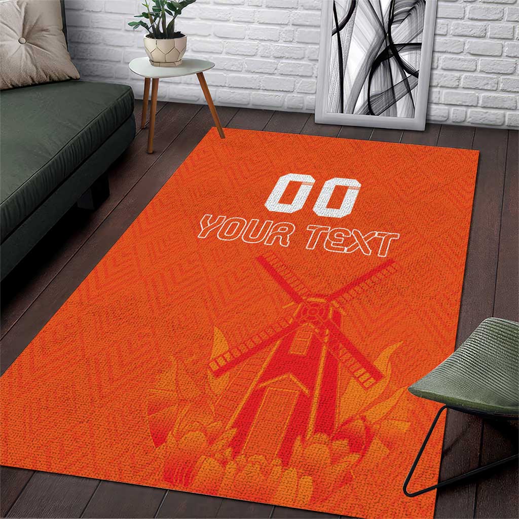 Orange area rug with windmill pattern and customizable 'YOUR TEXT' over centered design