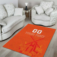 Orange area rug featuring windmill graphic and 'YOUR TEXT' in white, centered