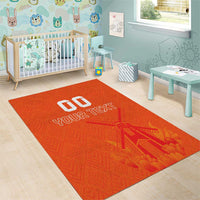 Orange area rug with windmill design and white 'YOUR TEXT' typography