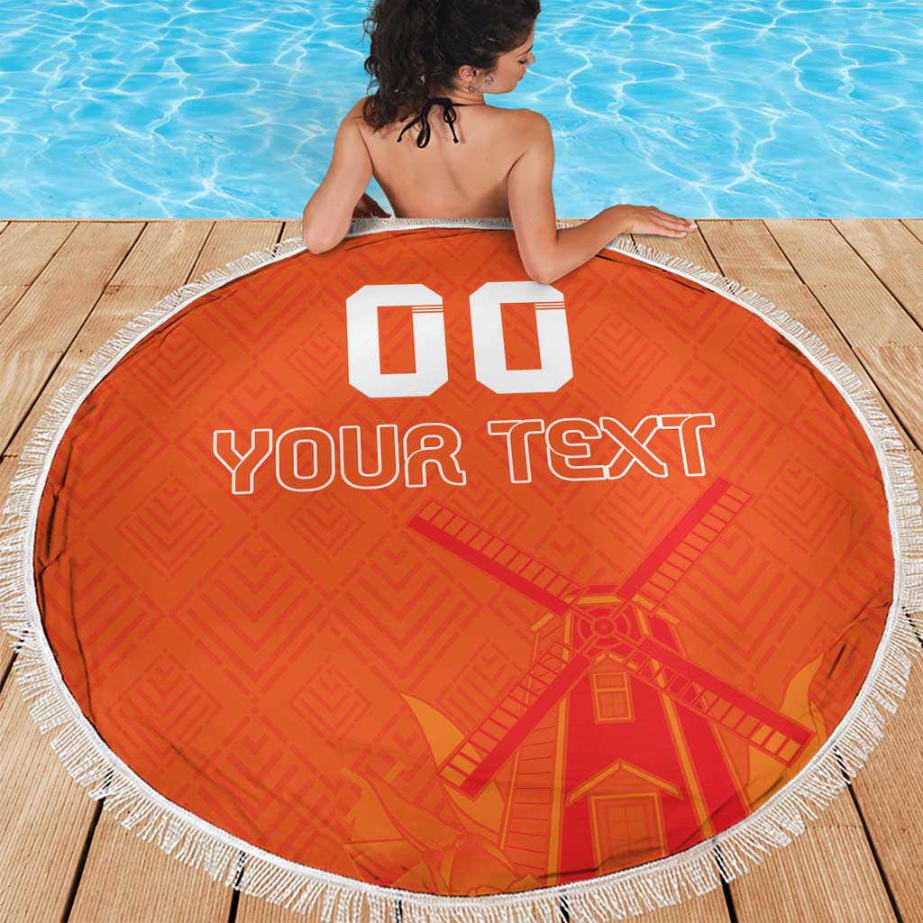 Orange round beach blanket with white fringe, custom text and windmill pattern