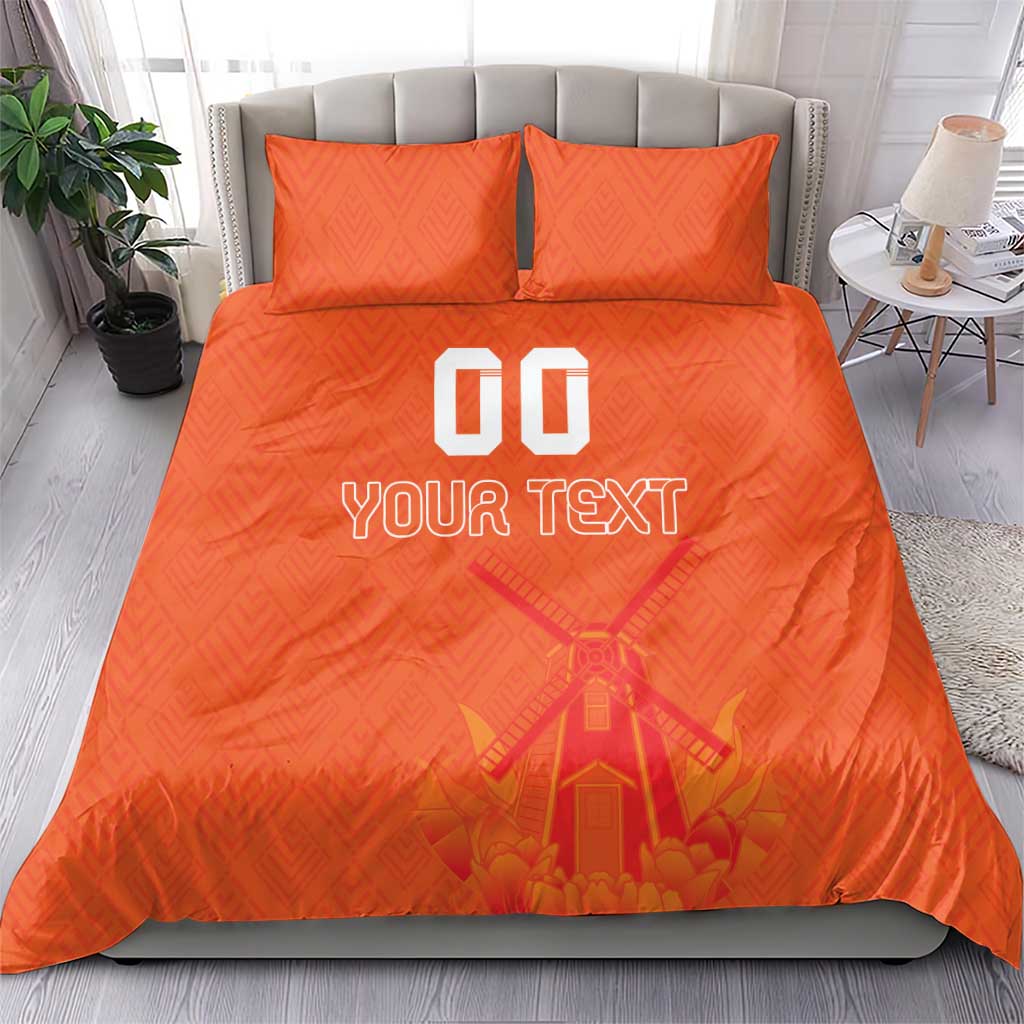 Orange duvet cover set with two pillows, windmill graphic and “YOUR TEXT” print.