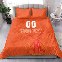 Orange duvet cover set with two pillows, windmill graphic and “YOUR TEXT” print.