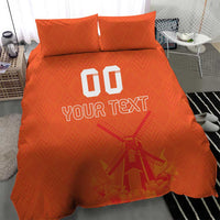 Orange bedding set with two matching pillows and duvet, windmill graphic under “YOUR TEXT”.