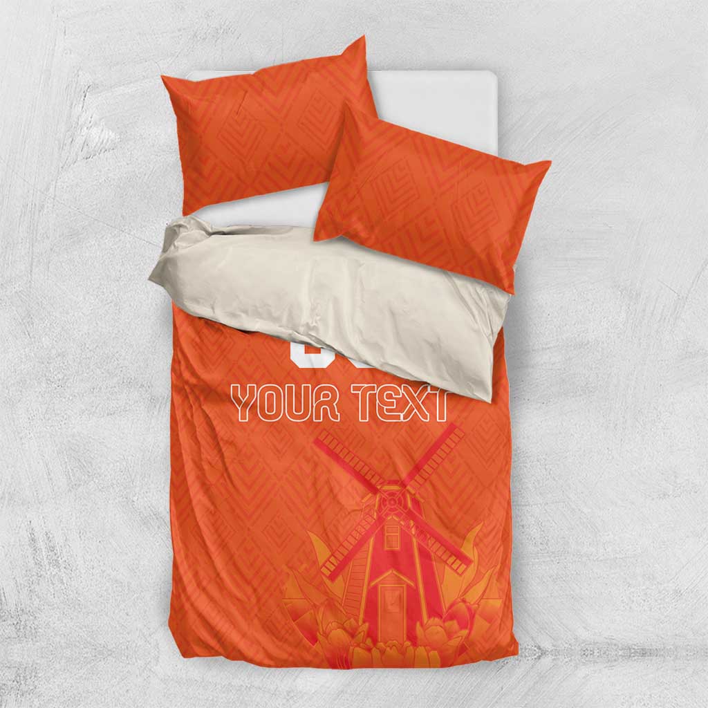 Orange bedding set with two pillows and duvet, “YOUR TEXT” over windmill tulip artwork.