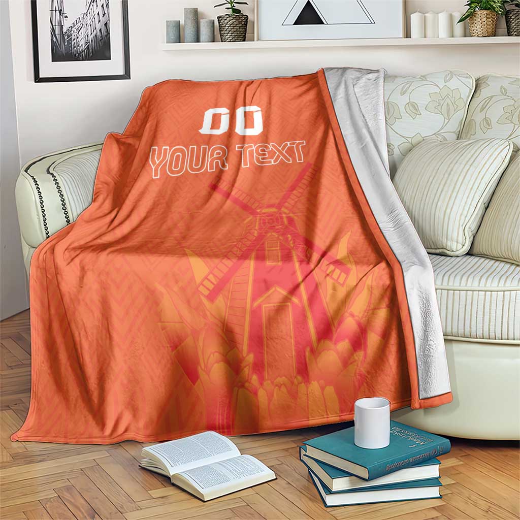 Orange rugby blanket with windmill and tulip pattern, 'YOUR TEXT' and '00'
