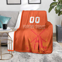 Orange rugby blanket with white edging, windmill and tulip pattern, 'YOUR TEXT' and '00'