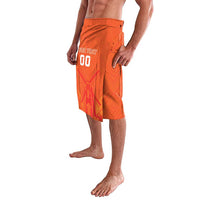 Orange patterned drawstring shorts with side slit detail and visible pocket