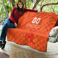 Orange quilt blanket laid on a patio seat, with custom jersey text and number graphic visible.