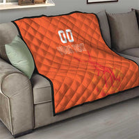 Orange quilt blanket draped on a sofa, with custom jersey text and number graphic in center.