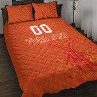 Orange quilt bed set with quilted pattern, two pillow covers, and 'YOUR TEXT'