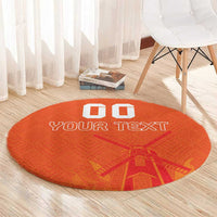 Orange round rug with “YOUR TEXT” and windmill-style pattern, custom blocks
