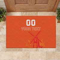 Orange rubber doormat with custom text and windmill, tulip graphic, jersey pattern