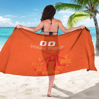 Orange sarong towel with back-center 'YOUR TEXT' graphic and decorative windmill print