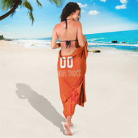 Orange sarong towel worn as skirt with back '00' and 'YOUR TEXT' graphic