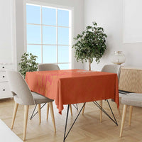 Orange tablecloth with windmill and tulips jersey pattern on rectangular dining table