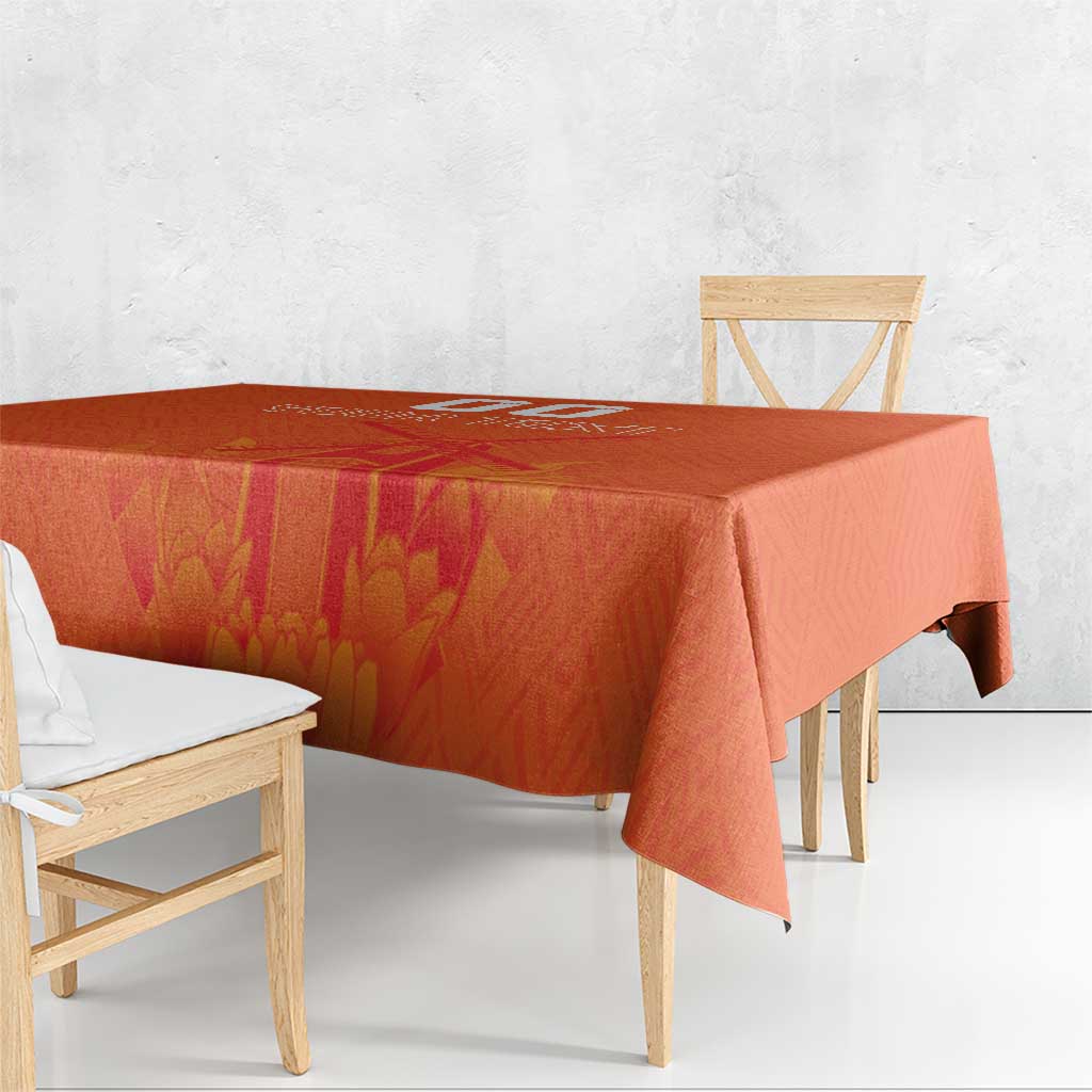 Orange tablecloth with windmill and tulips jersey pattern, corner drape on wooden benches