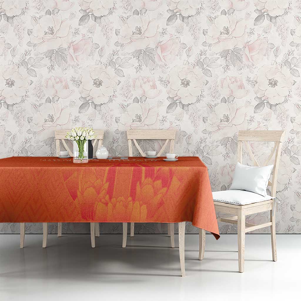 Orange tablecloth with windmill and tulips jersey pattern on dining table with chairs