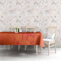 Orange tablecloth with windmill and tulips jersey pattern on dining table with chairs