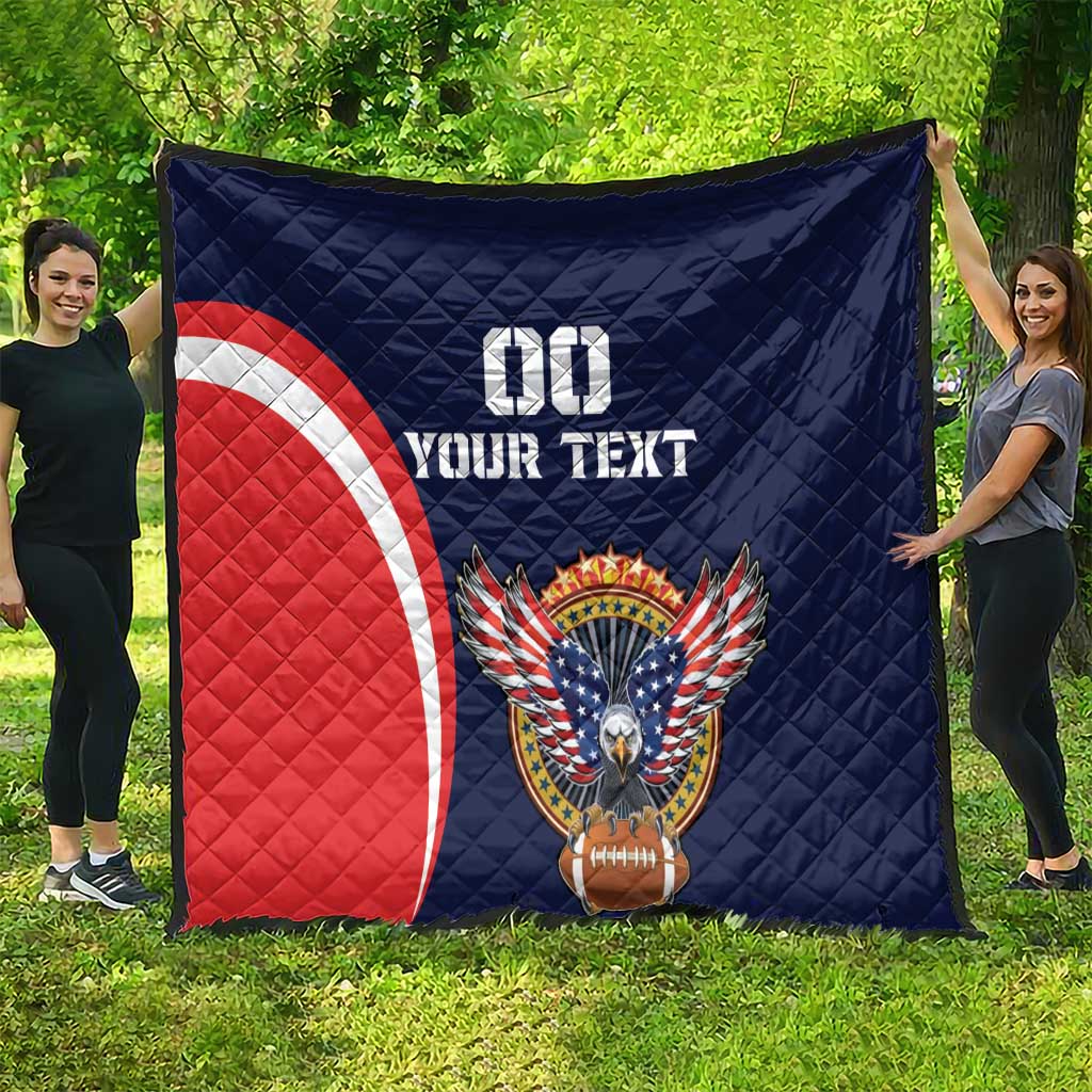 Blue rugby quilt with red-and-white arc, eagle and football emblem, displayed outdoors.