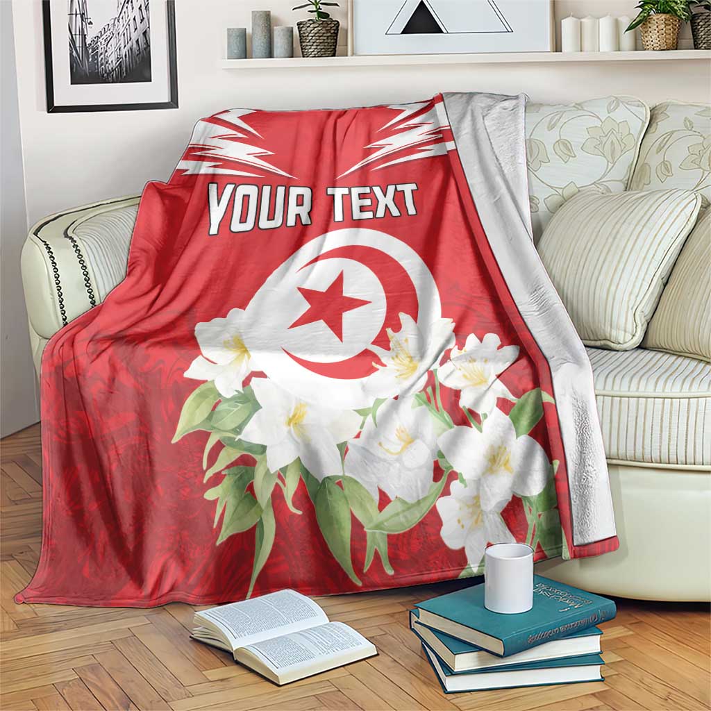 Red personalized Tunisia blanket with white emblem, jasmine flowers, and custom text