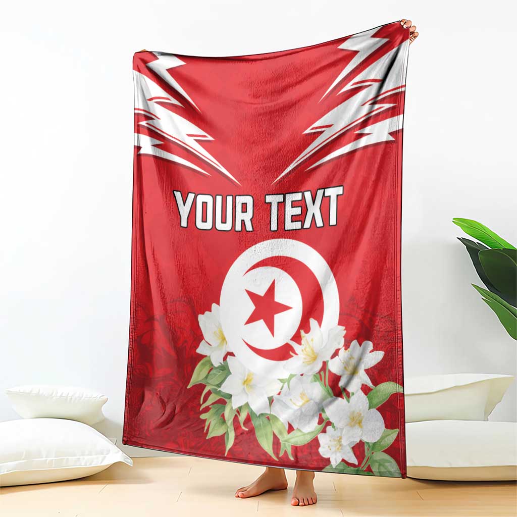 Red Tunisia blanket draped with white emblem, jasmine flowers, and custom text