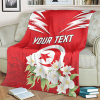 Red Tunisia blanket on armchair with white emblem, jasmine flowers, and custom text