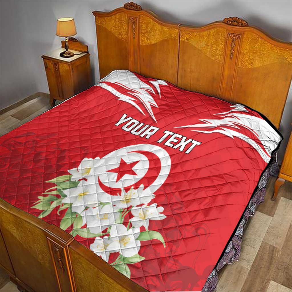 Red bed quilt with Tunisia emblem, jasmine flowers, and “YOUR TEXT” print