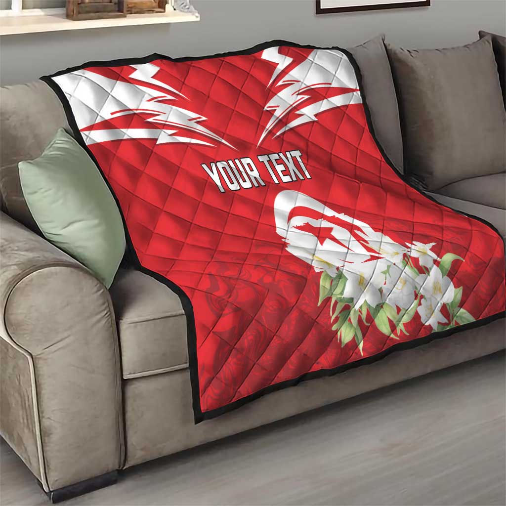 Red quilt with Tunisia emblem and jasmine floral accents, “YOUR TEXT” on top