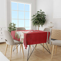 Red tablecloth with jasmine flower print and Tunisian emblem on dining table