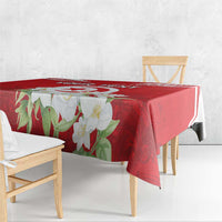 Red tablecloth with jasmine flower motif and Tunisian emblem trim on table