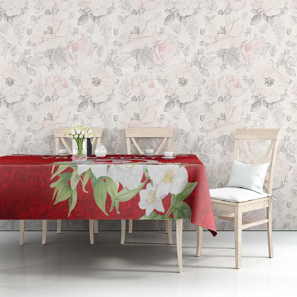 Red personalized tablecloth with jasmine floral print and Tunisian emblem across table