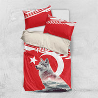 Personalized bedding set laid flat: red duvet and pillow set with wolf and “YOUR TEXT”