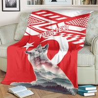 Red personalized wolf and Turkey flag style blanket over cream armchair