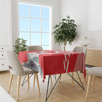 Red personalized tablecloth with mountain scene and check border on a dining table