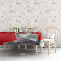 Red personalized tablecloth featuring mountain landscape, with chairs around the table