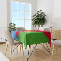 Eritrea flag-color tablecloth with central emblem, red/blue/green, on dining table.