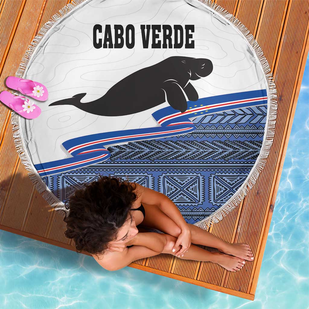 Round beach blanket with Cabo Verde text, black manatee, blue geometric stripe pattern and fringe