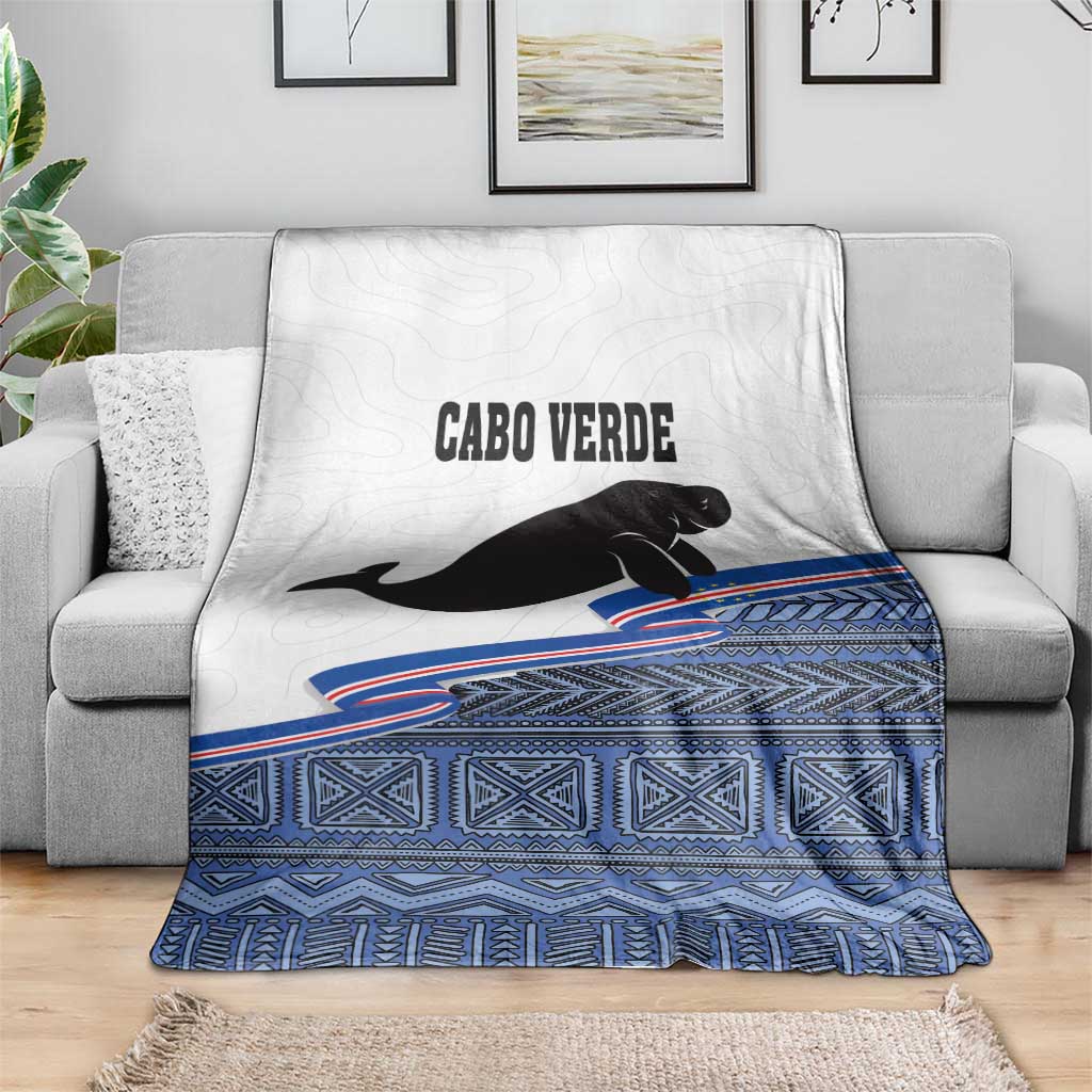 Cape Verde manatee throw blanket, white top with black manatee and blue patterned hem