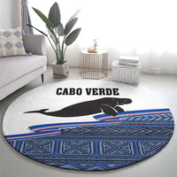 Round area rug featuring manatee graphic, Cabo Verde title, blue tribal-style band