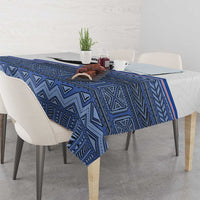 Blue tablecloth with geometric tribal motifs and thin red-and-white stripes