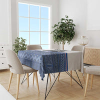 Blue geometric tablecloth on dining table with matching zigzag corner pattern