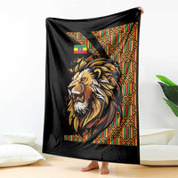 Black lion throw blanket with colorful Ethiopian-striped border, folded at corner