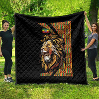Black quilt with diamond quilting and colorful lion print beside patterned column