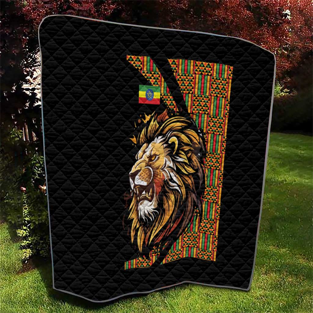 Black quilt with diamond quilting and lion portrait next to patterned vertical stripe