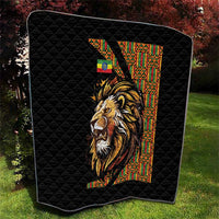Black quilt with diamond quilting and lion portrait next to patterned vertical stripe
