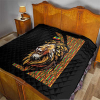 Black quilt with diamond quilting and lion face graphic on bed
