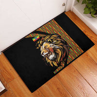Black rubber doormat with centered lion head design and multicolor patterned accent