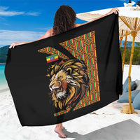 Black lion-print sarong with colorful geometric panel, wide draped wrap on model