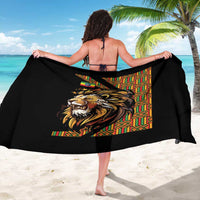 Black sarong with lion head design and multicolor patterned stripe, held across shoulders