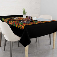 Black tablecloth with colorful Ethiopian-style panel border and lion artwork on table